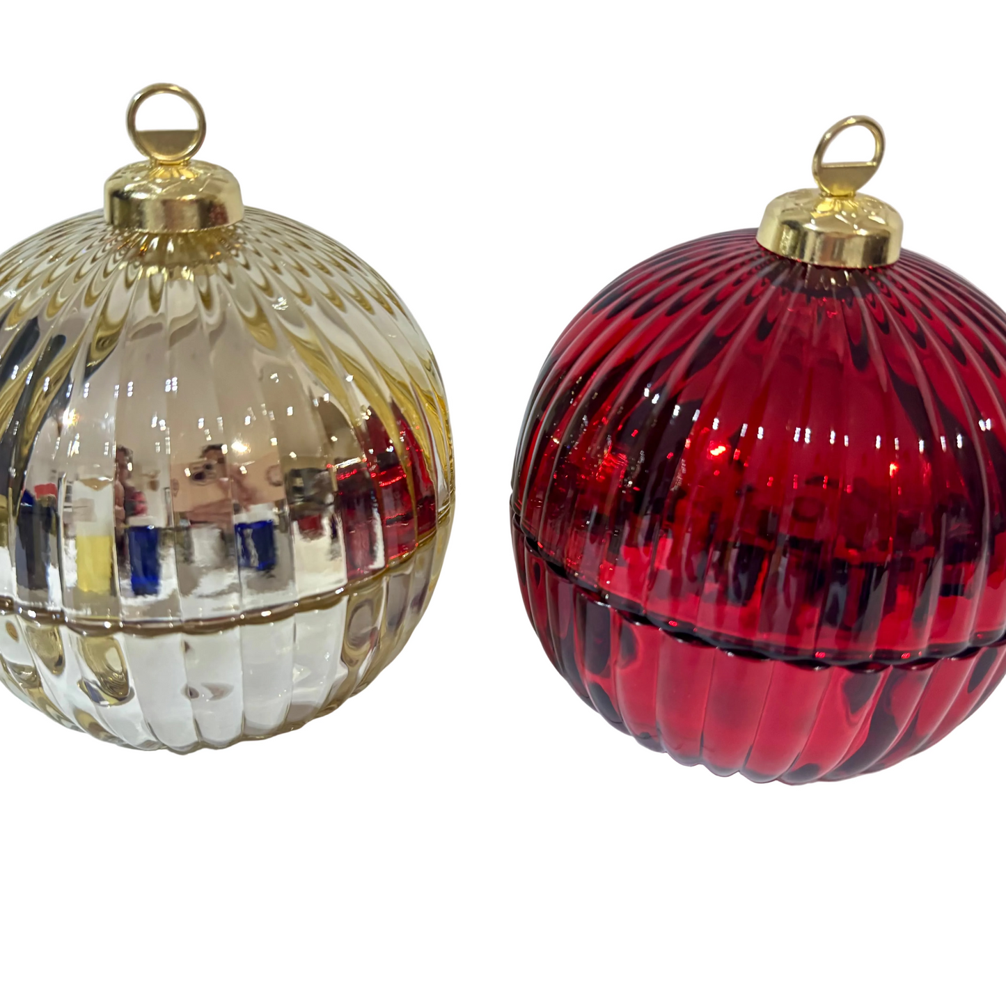 Gold and red ribbed glass Christmas bauble candles with gold tops on a white fabric background