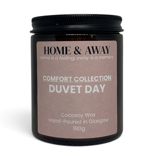 Duvet Day candle from the Comfort Collection in an amber glass jar with a black lid, hand-poured by Home & Away Candles