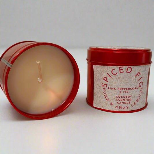 Spiced fig candle in a red tin with a label on a white background