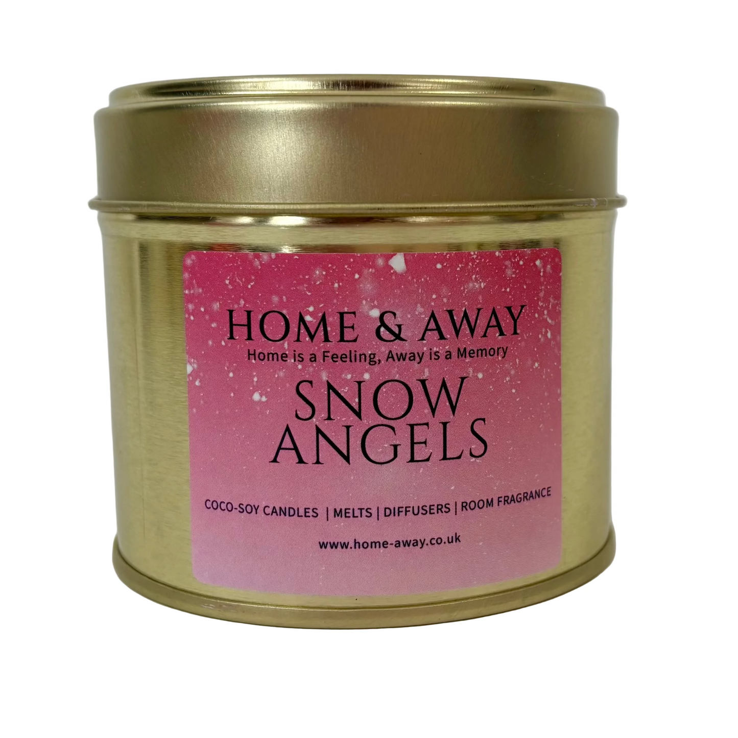 A cylindrical gold metal tin candle with a pink label reading 'HOME & AWAY SNOW ANGELS' on a plain light background.