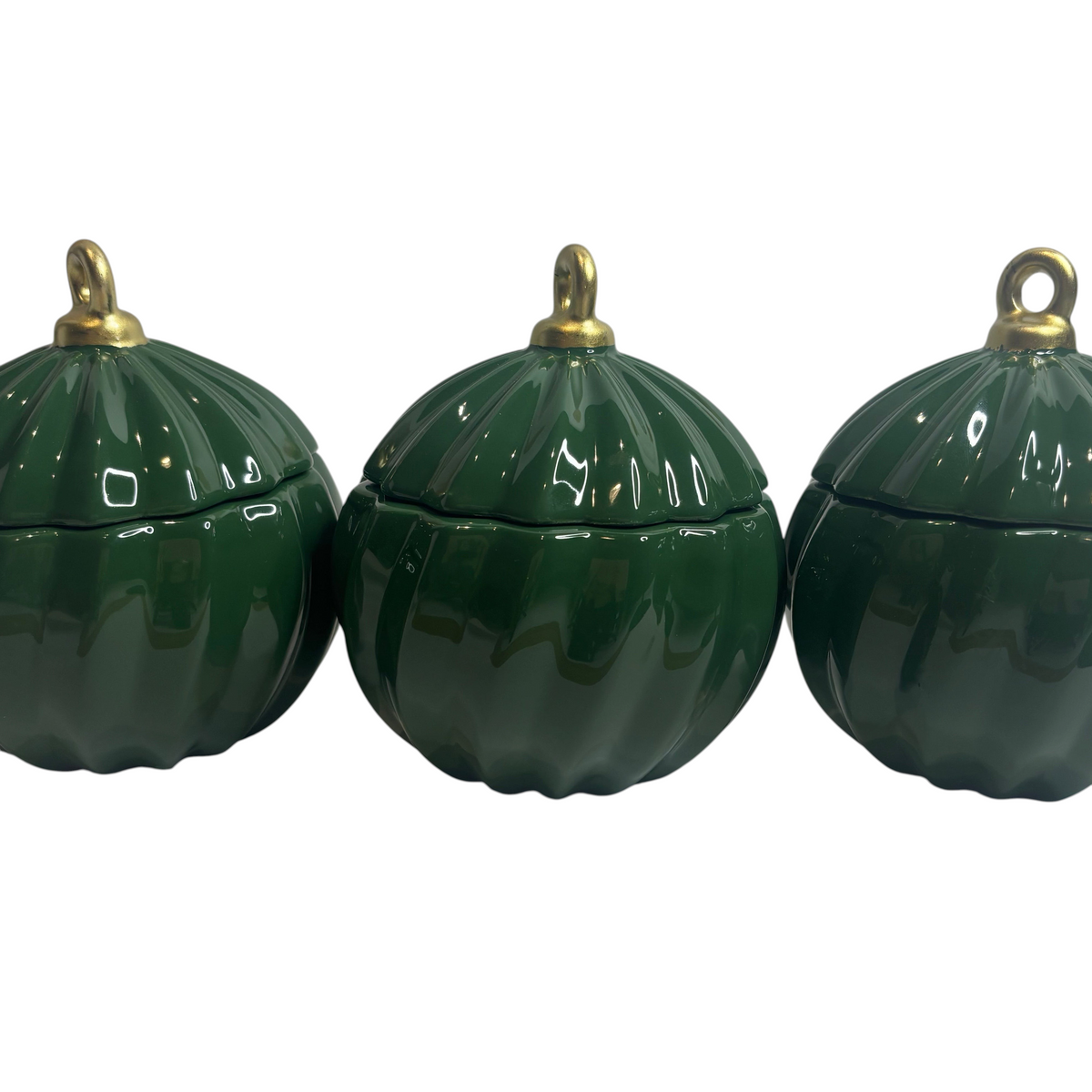 Three Home-away.co.uk glossy green ceramic Christmas bauble candles with gold hanging loops on a white background.